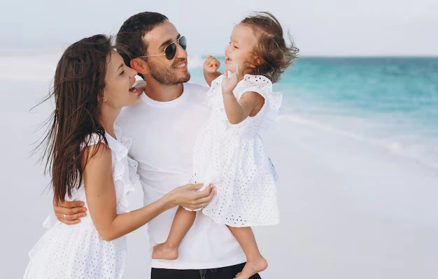 A Young family with their toddler near a seashore